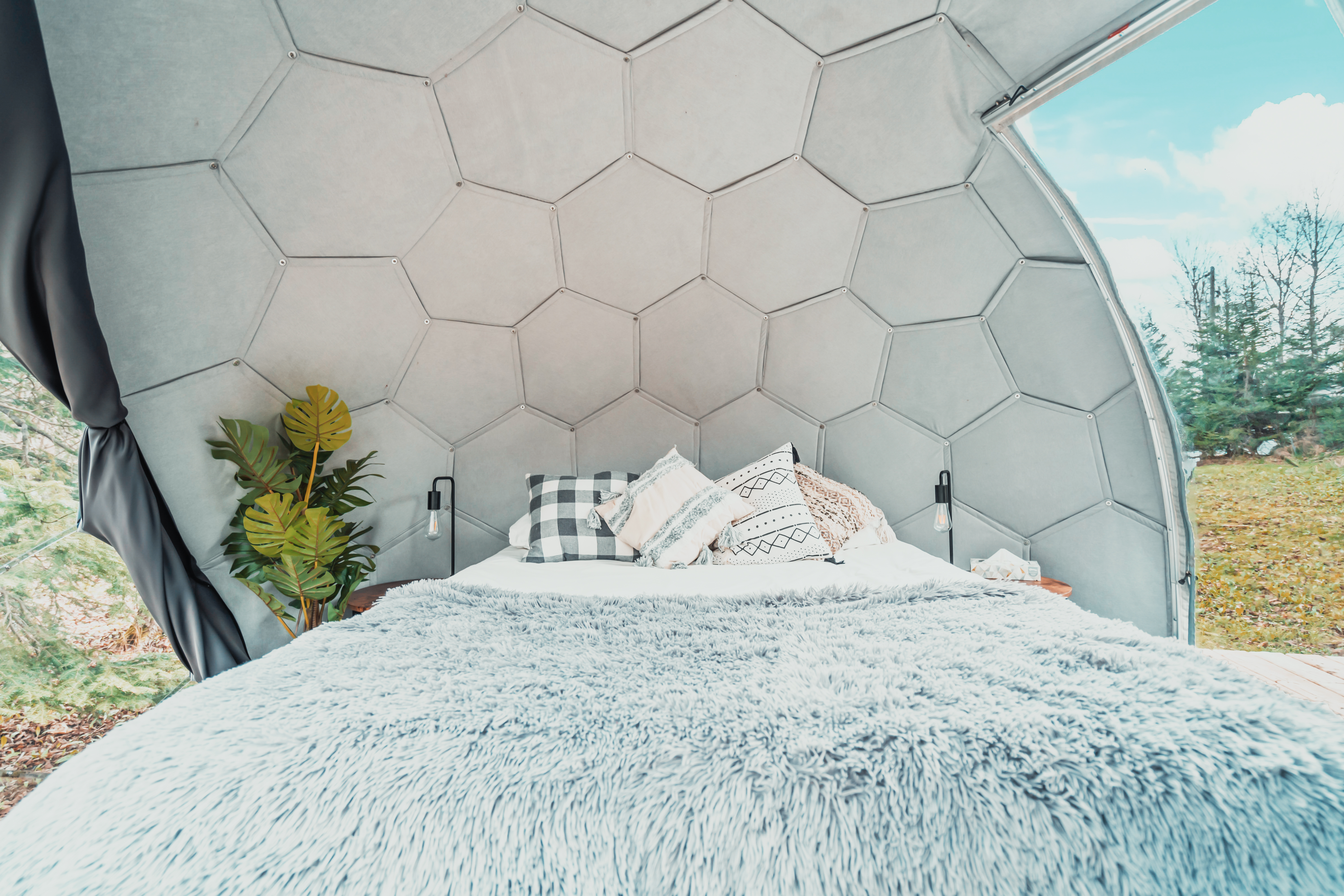 Stargazing through geodome with telescope under milky way night sky